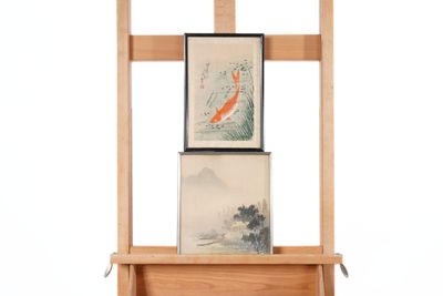 a wooden easel with two paintings on it