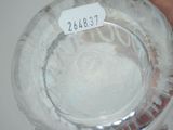 someone is holding a clear glass bowl with a label on it