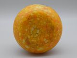 a close up of an orange on a white surface