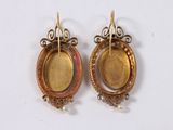 pair of gold and enamel earrings with pearls on a white background