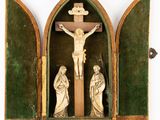a crucifix with jesus on the cross in a green case