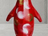 a red penguin figurine sitting on a table