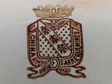 a close up of a vase with a crown on it