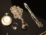 many different types of jewelry on a black table