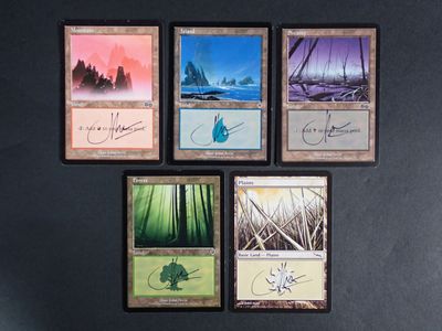 six cards with different designs on them on a black surface
