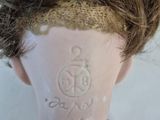 a close up of a doll ' s head with hair on it