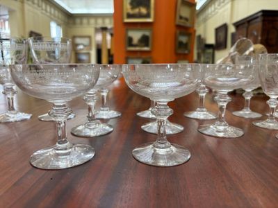 many empty wine glasses sitting on a table in a room