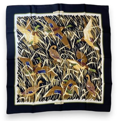 a square scarf with birds and grass on it