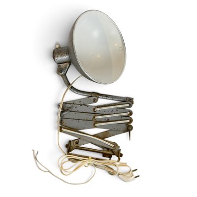 a light that is attached to a wall next to a bunch of clothes