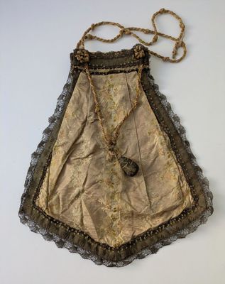 an old purse with a chain hanging from it ' s side