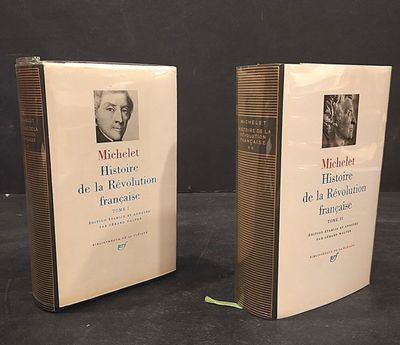 two books on a table with a black background and a black background