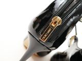 a close up of a pair of black high heeled shoes