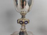 a silver chalicet with a blue and white design on it