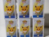 five boxes of pokemon pop vinyl figures sitting on top of a table