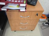 a red filing cabinet with a phone on top of it