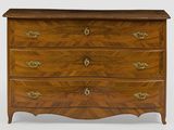 a wooden chest of drawers with brass handles and a chevron design