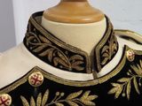 a close up of a black and gold uniform on a mannequin