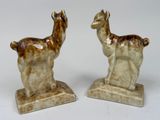 pair of ceramic llama bookends on marble base