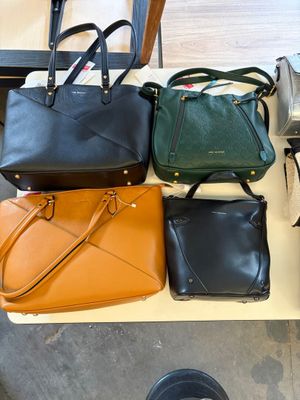 a lot of purses that are on a table