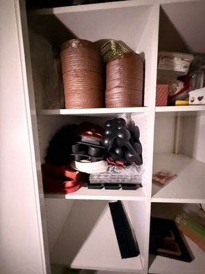 une étagère blanche sur laquelle sont disposés de nombreux objets divers