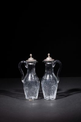 two clear glass vases sitting on top of a black table