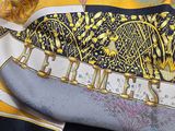a yellow and black scarf with a picture of a bird on it