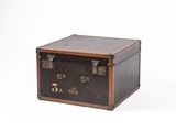 an old suitcase sitting on a white surface