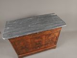 an old wooden chest with a marble top sitting on a white surface