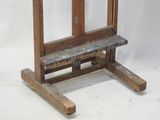 a small wooden easel with a bench on it