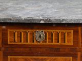 a marble top on a wooden chest of drawers