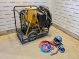 a couple of air compressors sitting on top of a cart in a room