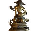 brass statue of a person sitting on top of a lotus