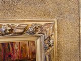 une photo d'un tableau accroché au mur à côté d'un miroir