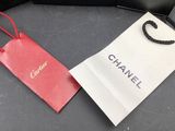 two chanel bags are sitting on a table next to each other