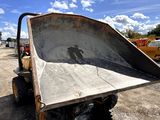 a dump truck that is sitting in the dirt