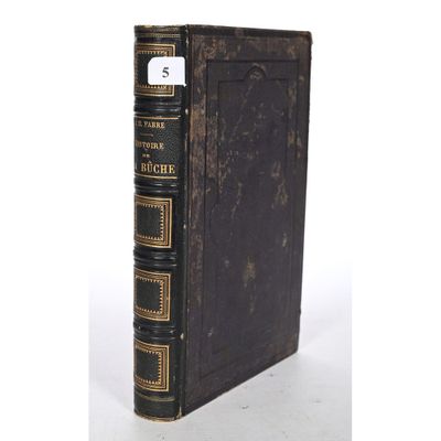 an old book sitting on top of a table next to a white background