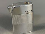 a silver lighter that is sitting on a table