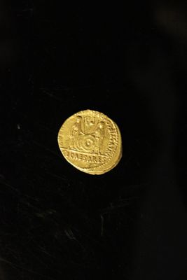 the gold coin is sitting on top of a black table