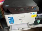 a printer that is sitting on top of a book shelf