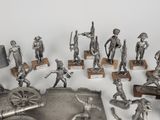 a lot of silver figurines of soldiers on display