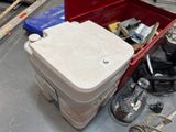 a red tool box with tools in it sitting on the floor