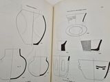 an open book with drawings of various objects on it