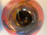 a close up of a colorful glass vase on a table