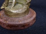 a bronze statue of a man sitting on a chair
