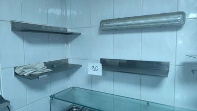 a glass shelf in a bathroom with towels on it