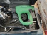 a green gas pump in a tool box on a table