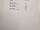 a receipt on the wall of a bathroom with a toilet in it
