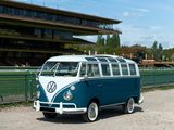 a blue and white vw bus parked on the side of the road