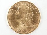 a close up of a gold coin with a woman ' s face on it