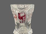 an antique cut glass vase with a red and white design